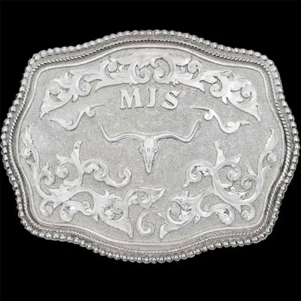 "Simplicity at its finest. Our Maybell Belt Buckle is crafted on a German Silver base, featuring a double line and bead edge, hand-engraved lettering, and intricate scrollwork. There is plenty of space to personalize this buckle with your choice of l
